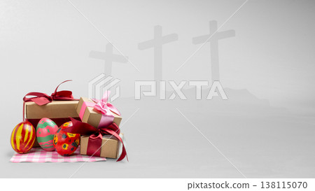Festive Easter eggs and gift boxes in the foreground with a symbolic background of three crosses on a hill, representing the religious and celebratory aspects of the holiday 138115070