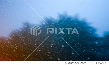 Soft snowflakes fall over a frosty landscape. Quiet, minimalistic winter beauty. 138115264