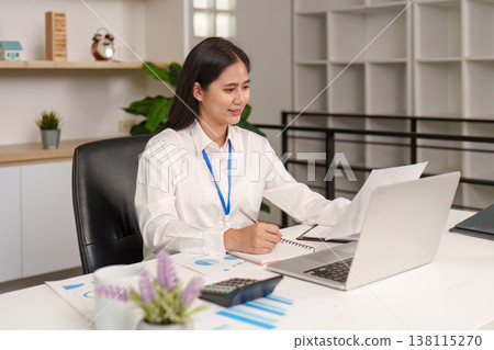 Accountant working on financial reports at desk Accountant working on financial reports at desk 138115270