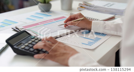 Accountant analyzing spreadsheets and financial data 138115294