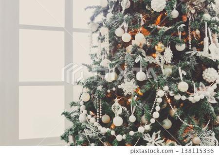 Christmas magic background. Beautiful decorated xmas tree in white living room. Shining lights, balls, baubles and garland. Winter holidays magic atmosphere. Modern design and decorations, copy space 138115336