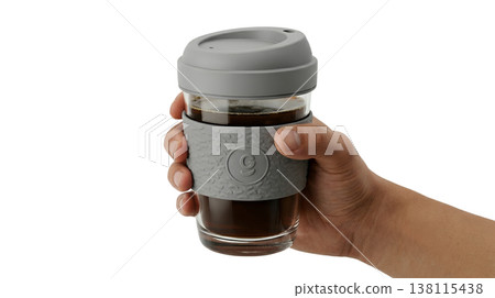 Hand holding an eco-friendly reusable glass coffee cup with a grey silicone lid and insulating sleeve, perfect for zero-waste lifestyle themes Hand holding an eco-friendly reusable glass coffee cup with a grey silicone lid and insulating sleeve, perfect for zero-waste lifestyle themes 138115438