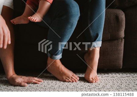 Family Bonding with Child on Sofa Relaxing Together 138115488