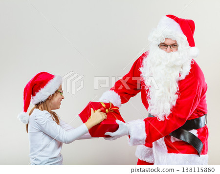 Santa Claus fighting with girl for present Santa Claus fighting with girl for present 138115860
