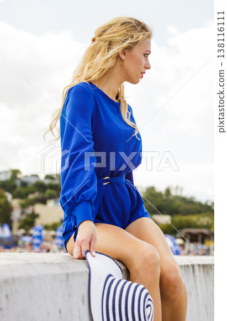 Fashion model posing with sun hat Fashion model posing with sun hat 138116111