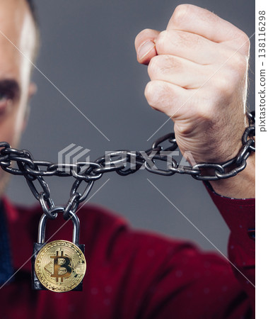 Man being tied up in block chain 138116298