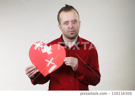Sad adult man holding broken heart Sad adult man holding broken heart 138116308