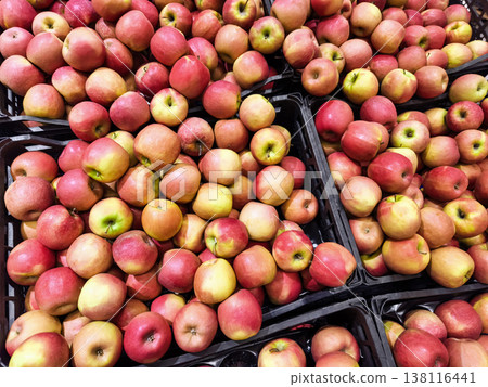 Fresh apples piled in baskets at a market during the daytime Fresh apples piled in baskets at a market during the daytime 138116441