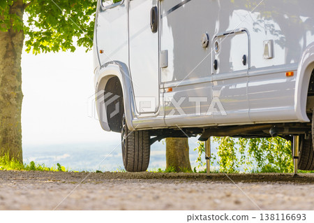 Camper with hydraulic leg in use. Rv levelling system Camper with hydraulic leg in use. Rv levelling system 138116693