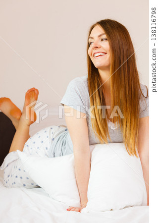 Cheerful girl rolling in bed. 138116798