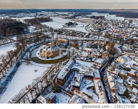Aerial view of the historic town of s-Heerenberg in winter. Features the medieval Huis Bergh castle with its moat, a Gothic church, and snow covered rooftops under a bright seasonal sky. Aerial view of the historic town of s-Heerenberg in winter. Features the medieval Huis Bergh castle with its moat, a Gothic church, and snow covered rooftops under a bright seasonal sky. 138117150