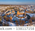 Aerial view of the medieval Huis Bergh Castle in s-Heerenberg, Netherlands. A stunning winter scene with a snow covered fortress, frozen moat, and a charming European town during golden hour. 138117158