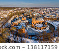 Aerial view of the medieval Huis Bergh Castle in s-Heerenberg, Netherlands. A stunning winter scene with a snow covered fortress, frozen moat, and a charming European town during golden hour. 138117159