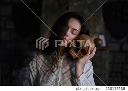 Enigmatic woman studies relic skulls in shadowed gothic room with mysterious ambiance Enigmatic woman studies relic skulls in shadowed gothic room with mysterious ambiance 138117386