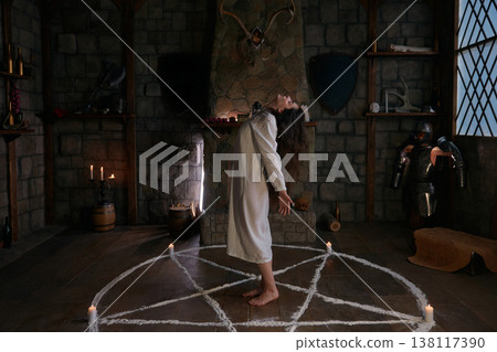 Woman summoning mystical forces within ancient surroundings Woman summoning mystical forces within ancient surroundings 138117390