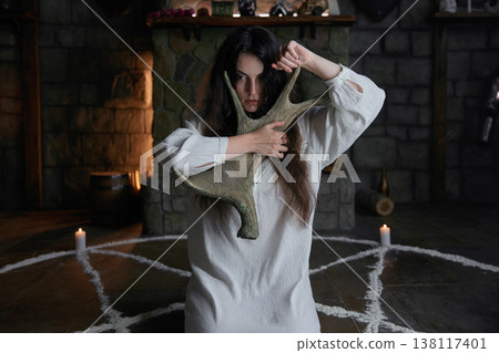 Woman performs arcane spell exorcism rituals, candlelit fortress surroundings Woman performs arcane spell exorcism rituals, candlelit fortress surroundings 138117401