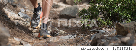 Walking or running exercise legs on rocky footpath in bright forest achievement fitness adventure and exercising in spring or summer nature motivation and inspirational activity 138118315