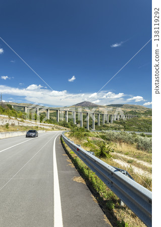 Driving car on rural road near viaduct Agnone Italy 138119292