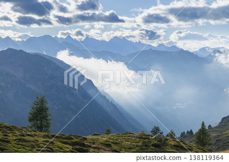 Alpine mountains with clouds and sun rays in Piedmont, Italy Alpine mountains with clouds and sun rays in Piedmont, Italy 138119364