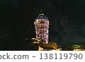 The illuminated observation tower and spiral staircase shine brightly against the night sky. 138119790