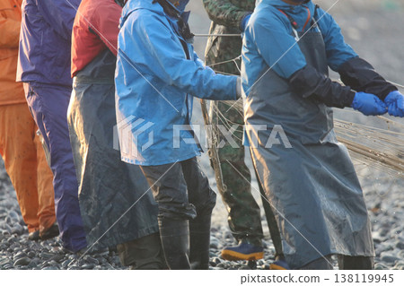 Fishermen pulling nets from the shore 138119945
