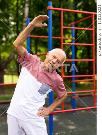 Senior man doing warming up exercises Senior man doing warming up exercises 138120221