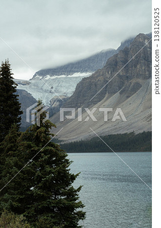 Bow Lake under a cloudy sky and the encroaching Crowfoot Glacier. 138120525