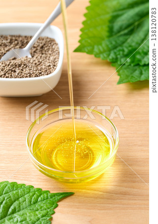 Pour perilla oil into a small dish. Pour perilla oil into a small dish. 138120783