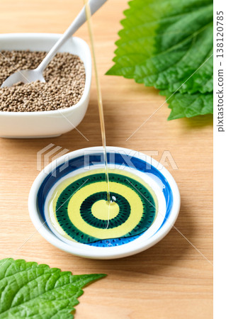 Pour perilla oil into a small dish. Pour perilla oil into a small dish. 138120785