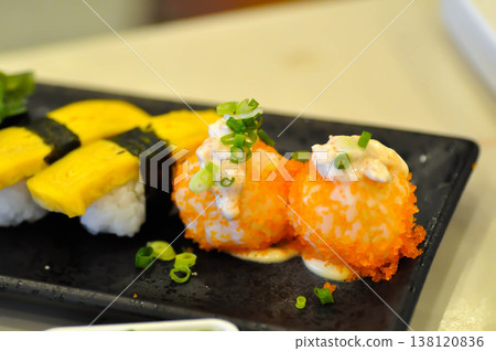 shrimp egg rolls or rice topped with fish or Japanese rolls 138120836