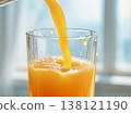 Pouring Freshly Squeezed Orange Juice into Glass Close-up 138121190