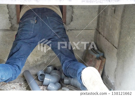 A scene of someone crawling into a house through a ventilation opening during an inspection. A scene of someone crawling into a house through a ventilation opening during an inspection. 138121662