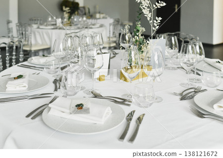Minimal wedding place setting with glass plates vases and eucalyptus sprigs Minimal wedding place setting with glass plates vases and eucalyptus sprigs 138121672