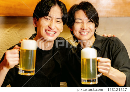 Two men toast each other. Two men toast each other. 138121817