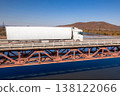 White truck on a bridge over the river 138122066