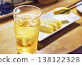 A cold green tea highball with plenty of ice and a rolled omelet. 138122328