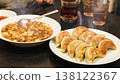A set of authentic Chinese food, including dumplings and mapo tofu, served on the table. 138122367