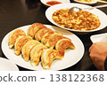 A set of authentic Chinese food, including dumplings and mapo tofu, served on the table. 138122368
