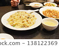 A table setting featuring fluffy fried rice—an authentic Chinese dining scene. 138122369