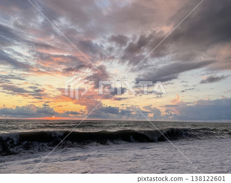 Sunset landscape. Sea wave and dramatic sunset sky with clouds Sunset landscape. Sea wave and dramatic sunset sky with clouds 138122601