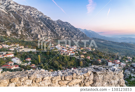 Rural countryside Albania. Mountain range with small town in the valley with sunset vibrant sky 138123853