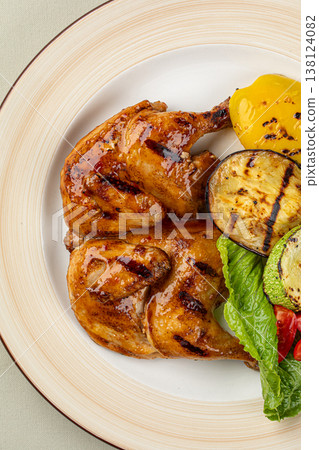 Grilled cornish chicken with vegetables on plate Grilled cornish chicken with vegetables on plate 138124082
