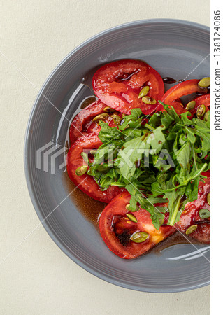Fresh tomato salad with greens in bowl 138124086