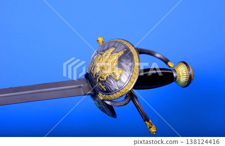 Sword Isolated over A Blue Background Sword Isolated over A Blue Background 138124416