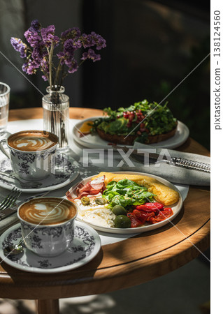 Breakfast table with omelette coffee and flowers 138124560