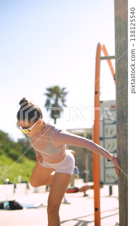 Female athlete adjusting stance during outdoor strength training session Female athlete adjusting stance during outdoor strength training session 138125540