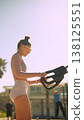 Relaxed female athlete engaged in cardio workout amidst tropical scenery 138125551