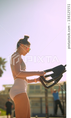 Relaxed female athlete engaged in cardio workout amidst tropical scenery Relaxed female athlete engaged in cardio workout amidst tropical scenery 138125551