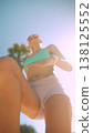 Powerful female athlete midstride in bright environment 138125552