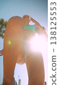 Caucasian athlete walking into sun flare, cinematic low angle 138125553